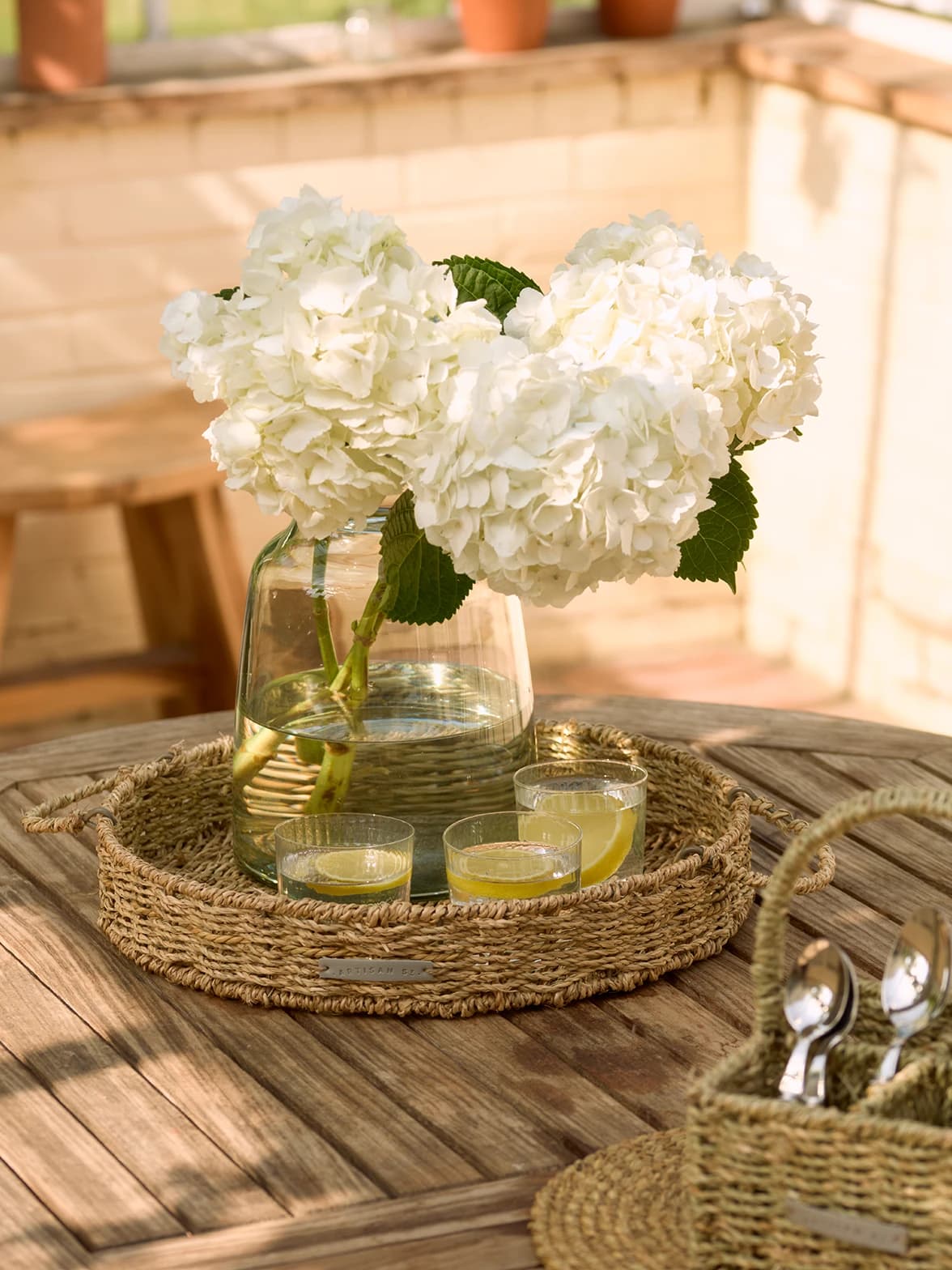 A seagrass tray with drinks in glasses
