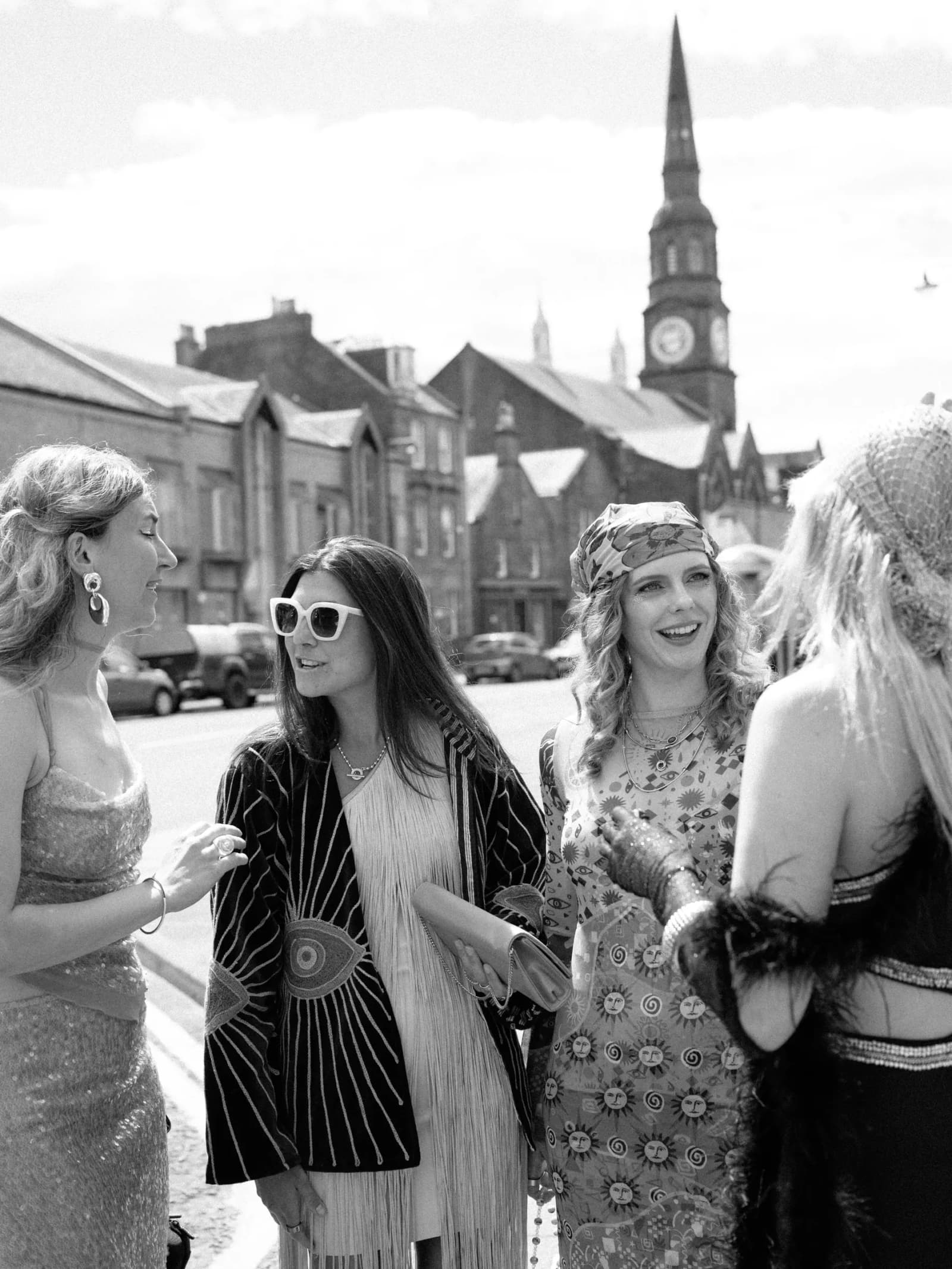 Guests in Studio 54 inspired outfits and sunglasses gathered outside the church in Forfar for a festival wedding in Scotland
