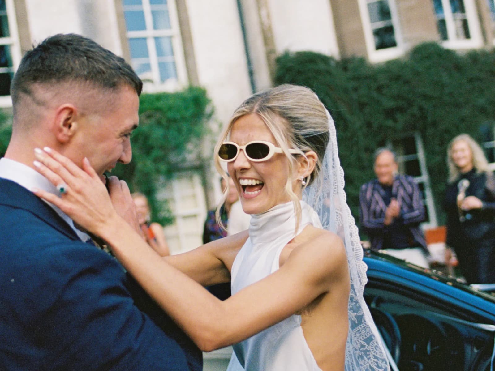 Newlyweds celebrating outside a historic family estate in Scotland